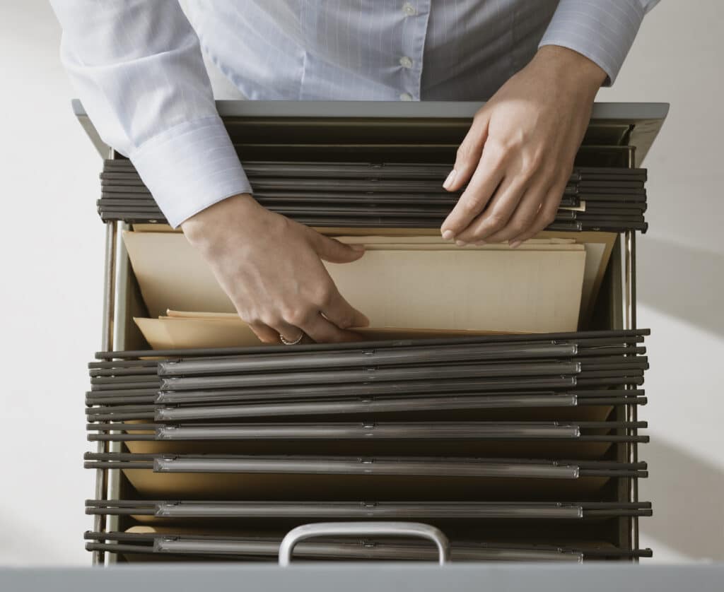 Office worker searching files in the archive