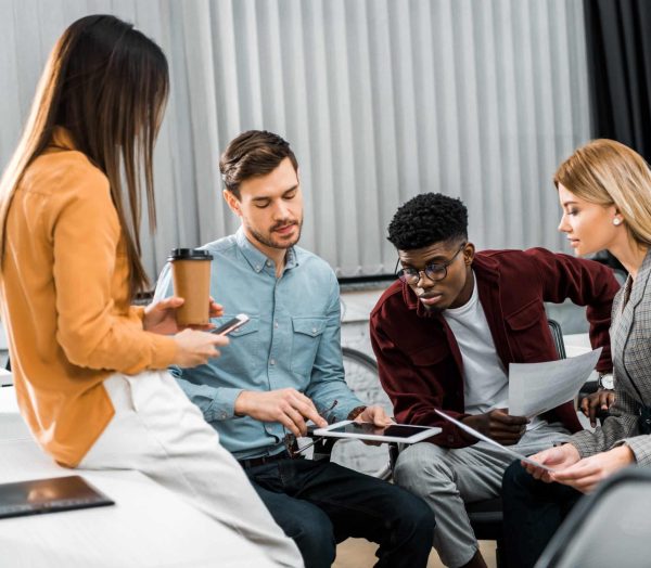 multicultural young businesspeople discussing new business idea in office