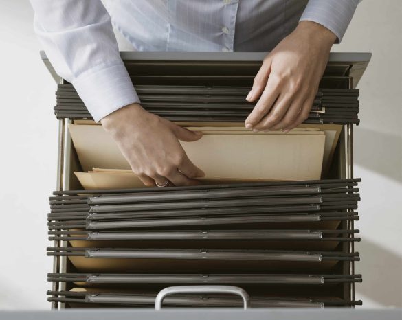 Office worker searching files in the archive